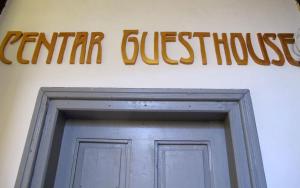 a sign above a door with a sign above it at Centar Guesthouse in Zagreb