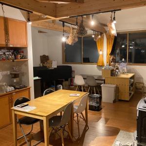 a kitchen and dining room with a wooden table and chairs at Okunikko Guesthouse JUN in Nikko