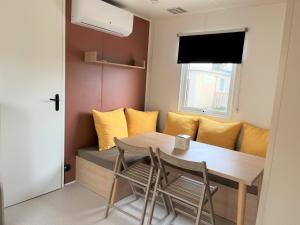 a small dining room with a table and chairs at Camping La Clape Village in Cap d'Agde