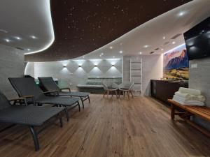 a waiting room with chairs and a couch at BudinSKI Apartmány & Wellness in Liptovský Mikuláš +18 photos
