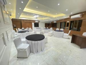 a meeting room with white chairs and tables in a building at HOTEL GOLDEN TULIPZ in Mumbai