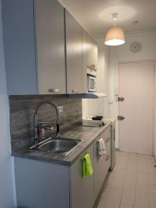 a kitchen with a sink and a microwave at Studio des Champs Elysées in Paris