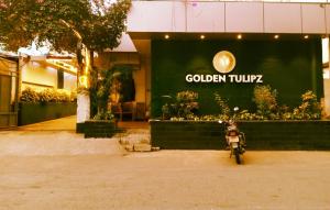 a motorcycle parked in front of a building at HOTEL GOLDEN TULIPZ in Mumbai