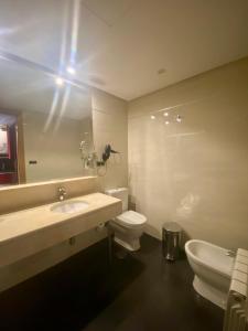 a bathroom with a sink and a toilet and a mirror at ArtPlatinum SUITES&APARTMENTS in Benalmádena