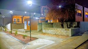 a house at night with a tree in front of it at 100 años ciprés in Río Gallegos