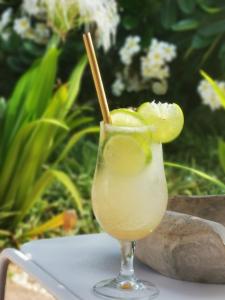 a drink in a glass sitting on a table at La Maison Vanille in Ngaparou