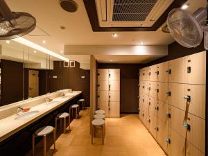 a bathroom with a row of sinks and toilets at APA Hotel Sapporo Odori Ekimae Minami in Sapporo +76 photos