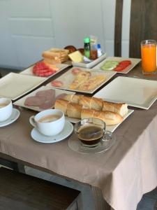 a table with plates of food and cups of coffee at Idyllic Samui Beach Villa Resort in Choeng Mon Beach