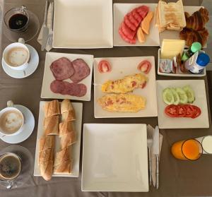 a table topped with boxes of breakfast foods and coffee at Idyllic Samui Beach Villa Resort in Choeng Mon Beach