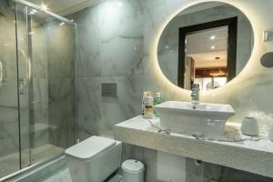 a bathroom with a sink and a shower and a toilet at B2 deluxe apartments in Alexandroupoli +18 photos