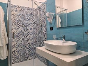 a bathroom with a sink and a shower at Maresol Residence in Bagnara Calabra