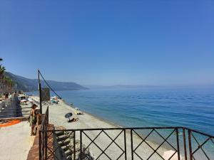 a beach with people on it and the water at Maresol Residence in Bagnara Calabra