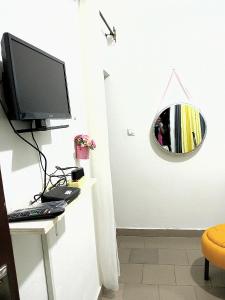 a room with a desk with a computer and a mirror at Studio meublé Yaoundé Ekounou in Yaoundé