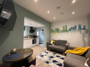 a living room with a couch and a table at Silk Apartments Spondon in Derby