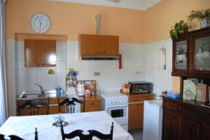a kitchen with a table and a clock on the wall at B&B La Cà Cita in Cortazzone