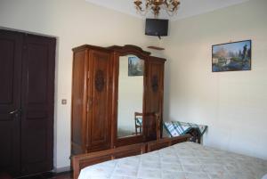 a bedroom with a wooden cabinet and a bed at B&B La Cà Cita in Cortazzone