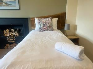 a large white bed with a pillow on top of it at New Ing Lodge in Shap