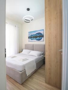 a bedroom with a bed and a sliding door at Modern Apt in Mangalem21 Complex WiFi,AC in Tirana