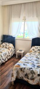 Ένα ή περισσότερα κρεβάτια σε δωμάτιο στο Bel appartement Savannah Beach