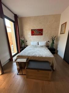 a bedroom with a large bed and a large window at L’Egyptienne in Antibes