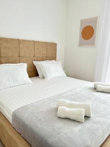 two beds with white sheets and two towels on them at Aurus 2 in Korčula