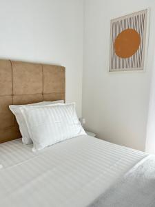 a bed with white sheets and pillows in a bedroom at Aurus 2 in Korčula