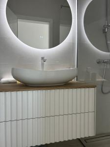 a bathroom with a white sink and a mirror at Aurus 2 in Korčula