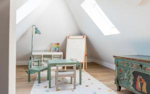 a room with chairs and a table and a chalkboard at Up Hus Hotel Neuruppin in Neuruppin
