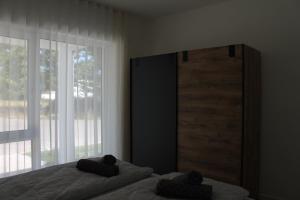 a bedroom with two beds and a large window at Ferienwohnung Wiesflecken in Balingen