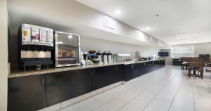 a kitchen with a counter and a dining room at SureStay Plus Hotel by Best Western Rocklin in Rocklin