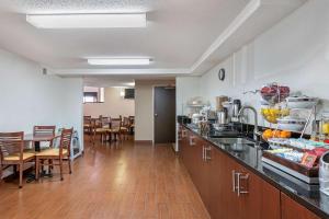 a kitchen with a counter and a table and chairs at Sleep Inn DeWitt in DeWitt