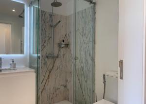 a shower with a glass door in a bathroom at Quinta de Santa Marinha in Castedo