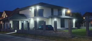 a house with a car parked in front of it at Casira Guesthouse in Sînmartin