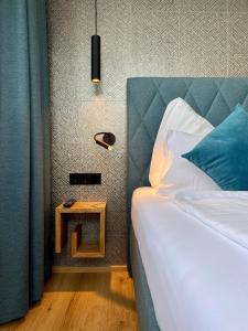 a bedroom with a bed and a table with a lamp at Wolf & Schaf Apartments in St. Wolfgang