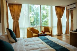 a bedroom with a bed and a large window at Hotel Black Diamond - Inside Airport in Kathmandu