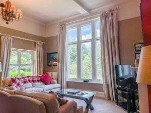 a living room with a couch and a tv at Geltsdale Garden Apartment ground floor home in Wetheral close to Carlisle & Ullswater in Wetheral