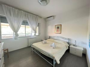 Postel nebo postele na pokoji v ubytování Imperiale Apartment