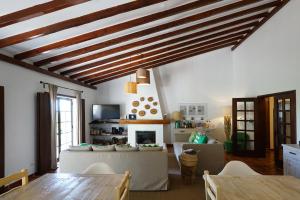 a living room with a table and a fireplace at Vale Fuzeiros Nature Guest House in Vale Fuzeiros