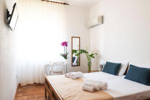 a bedroom with a bed with towels on it at Hotel L'Aragosta in La Caletta +116 photos