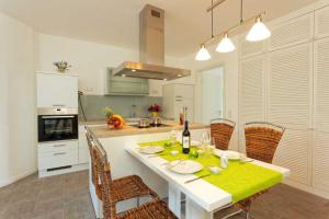 a kitchen with a white table with a yellow table cloth at Lotsenstieg 2 Kajuete 03 in Ostseebad Karlshagen