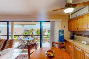 a kitchen and dining room with a table and a balcony at La Costa Beautiful Golf Villa in San José del Cabo