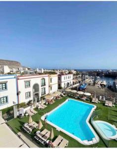 a view of a swimming pool next to a building at Casa Apolo in Mogán