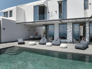 a house with a swimming pool in front of a house at Olvos Luxury Villas Porto Heli in Porto Heli