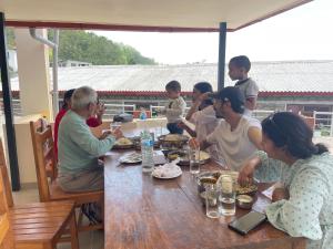 a group of people sitting at a table eating food at KAT RESORT PVT.LTD in Kakani
