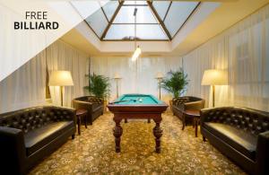a billiard room with couches and a pool table at Hotel St George - Czech Leading Hotels in Prague