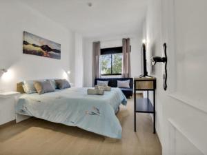 a white bedroom with a bed and a desk at 212 Elegant, renovated, confortable Playa Paraiso in Playa Paraiso +19 photos