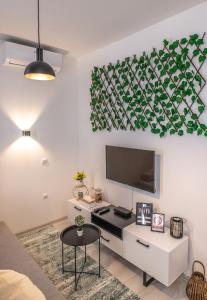 a living room with a flat screen tv on a wall at FIT Apartments in Sarajevo