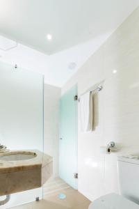 a bathroom with a shower and a sink and a toilet at Hotel Madeira in Funchal