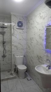 a white bathroom with a toilet and a sink at Porto golf marina in El Alamein