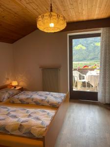 a bedroom with a bed and a window with a table at Haus Käfersberg in Naturno